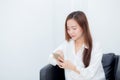 Beautiful of portrait young asian woman smiling sitting relax on the chair, girl using mobile smart phone Royalty Free Stock Photo