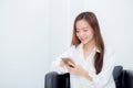 Beautiful of portrait young asian woman smiling sitting relax on the chair, girl using mobile smart phone Royalty Free Stock Photo