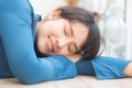 Beautiful portrait young asian woman smiling sleep at cafe, model girl happy with relax and resting, female lying Royalty Free Stock Photo