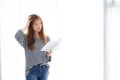 Beautiful portrait young asian woman standing reading book for exam with serious and stress in the room at home Royalty Free Stock Photo
