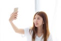 Beautiful portrait young asian woman taking a selfie with smart Royalty Free Stock Photo