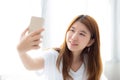 Beautiful portrait young asian woman taking a selfie with smart Royalty Free Stock Photo