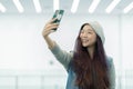 Beautiful portrait young asian woman taking a selfie with smart mobile phone, girl is photographing with happy and smile Royalty Free Stock Photo