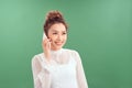 Beautiful of portrait young Asian woman talk smart phone over green background Royalty Free Stock Photo