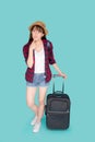 Beautiful portrait young asian woman thinking idea travel in vacation with luggage isolated on blue background Royalty Free Stock Photo