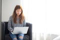 Beautiful of portrait young asian woman using laptop computer for leisure on chair at living room Royalty Free Stock Photo