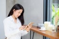 Beautiful portrait young asian woman using tablet computer in the coffee shop. Royalty Free Stock Photo