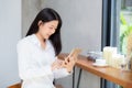 Beautiful portrait young asian woman using tablet computer in the coffee shop. Royalty Free Stock Photo