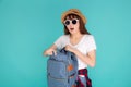 Beautiful portrait young asian woman wear sunglasses and hat open backpack and surprise travel summer trip holiday Royalty Free Stock Photo
