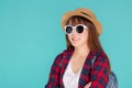 Beautiful portrait young asian woman wear sunglasses and hat smile expression confident enjoy summer holiday isolated blue Royalty Free Stock Photo