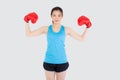 Beautiful portrait young asian woman wearing red boxing gloves flexing with strength and strength isolated Royalty Free Stock Photo