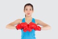 Beautiful portrait young asian woman wearing red boxing gloves with strength and strength isolated on white background Royalty Free Stock Photo