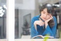 Beautiful portrait young asian woman writer smiling thinking idea and writing on notebook or diary with happy Royalty Free Stock Photo