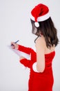 Beautiful portrait young asian woman writing notepad in xmas day isolated on white background Royalty Free Stock Photo