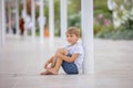 Beautiful portrait of young barefeet child, walking in Monaco, beautiful white terrace next to the beach Royalty Free Stock Photo