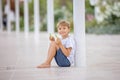 Beautiful portrait of young barefeet child, walking in Monaco, beautiful white terrace next to the beach Royalty Free Stock Photo