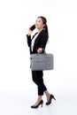 Beautiful portrait young business asian woman holding a briefcase and talking phone. Royalty Free Stock Photo