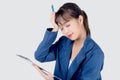 Beautiful portrait young business asian woman holding clipboard with worry and stressed about trouble of work isolated Royalty Free Stock Photo