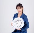 Beautiful portrait young business asian woman smiling holding clock isolated on white background Royalty Free Stock Photo