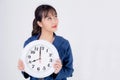 Beautiful portrait young business asian woman smiling holding clock isolated on white background Royalty Free Stock Photo