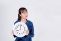 Beautiful portrait young business asian woman smiling holding clock isolated on white background Royalty Free Stock Photo