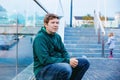 Beautiful portrait of young handsome man. Happy man looking at the camera and smiling. With reflections of him on window Royalty Free Stock Photo