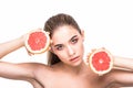 Beautiful close-up portrait of young woman with grapefruit. Healthy food concept. Skin care and beauty. Vitamins and minerals. Royalty Free Stock Photo