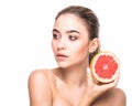 Beautiful close-up portrait of young woman with grapefruit. Healthy food concept. Skin care and beauty. Vitamins and minerals. Royalty Free Stock Photo