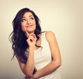 Beautiful positive young casual woman with finger under the face Royalty Free Stock Photo