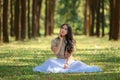 beautiful potrait asian woman siting in a pine forest at morning natural light