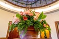 Beautiful potted colorful flowers with leaves under stained glass dome roof