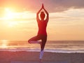 Beautiful practicing yoga on beach. Sea and sunset sky background. Yoga concept. Royalty Free Stock Photo