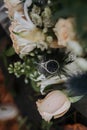 Beautiful and precious diamond engagement ring put on a bouquet of roses