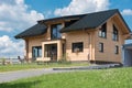 Beautiful prefabricated house with meadow under blue sky