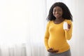 Beautiful pregnant black woman showing her supplements Royalty Free Stock Photo