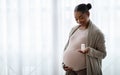 Beautiful pregnant black woman showing her supplements for future mothers Royalty Free Stock Photo