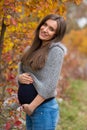 Beautiful pregnant brunette in nature