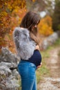 Beautiful pregnant brunette in nature