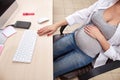 Beautiful pregnant business woman in the office. Business concept. Royalty Free Stock Photo