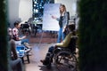 Beautiful pregnant Businesswoman Gives Report/ Presentation to Her Business Colleagues in the Conference Room