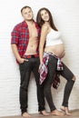 Beautiful pregnant couple smiling and hugging. Love and tenderness in anticipation of a miracle. Royalty Free Stock Photo