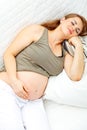 Beautiful pregnant female sleeping on sofa Royalty Free Stock Photo