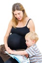 Beautiful pregnant happy mother with child boy reading book isolated Royalty Free Stock Photo