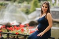 Beautiful pregnant lady in blue dress smile. Tenderness woman walk outside. Six months of pregnancy