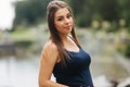 Beautiful pregnant lady in blue dress smile. Tenderness woman walk outside. Six months of pregnancy