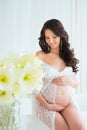 Beautiful pregnant in light white lace negligee in the bathroom Royalty Free Stock Photo