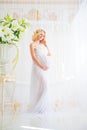 Beautiful pregnant in light white lace negligee in the bathroom Royalty Free Stock Photo