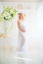 Beautiful pregnant in light white lace negligee in the bathroom Royalty Free Stock Photo