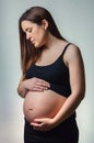 Beautiful pregnant looking her belly isolated Royalty Free Stock Photo