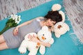 Beautiful pregnant mother with teddy bears. Motherhood Royalty Free Stock Photo